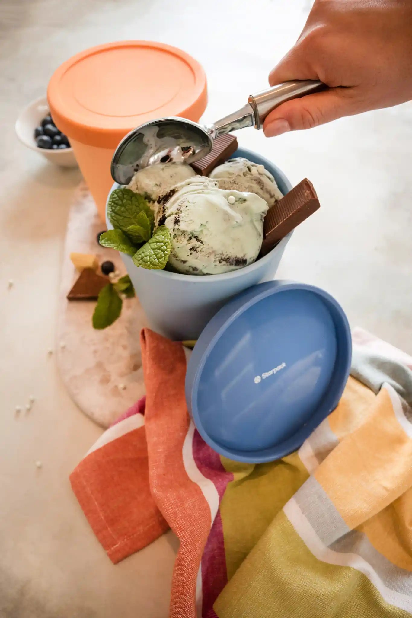 Starpack ice cream freezer storage containers with colorful, leak-proof silicone lids, designed for easy stacking and frost-free storage.