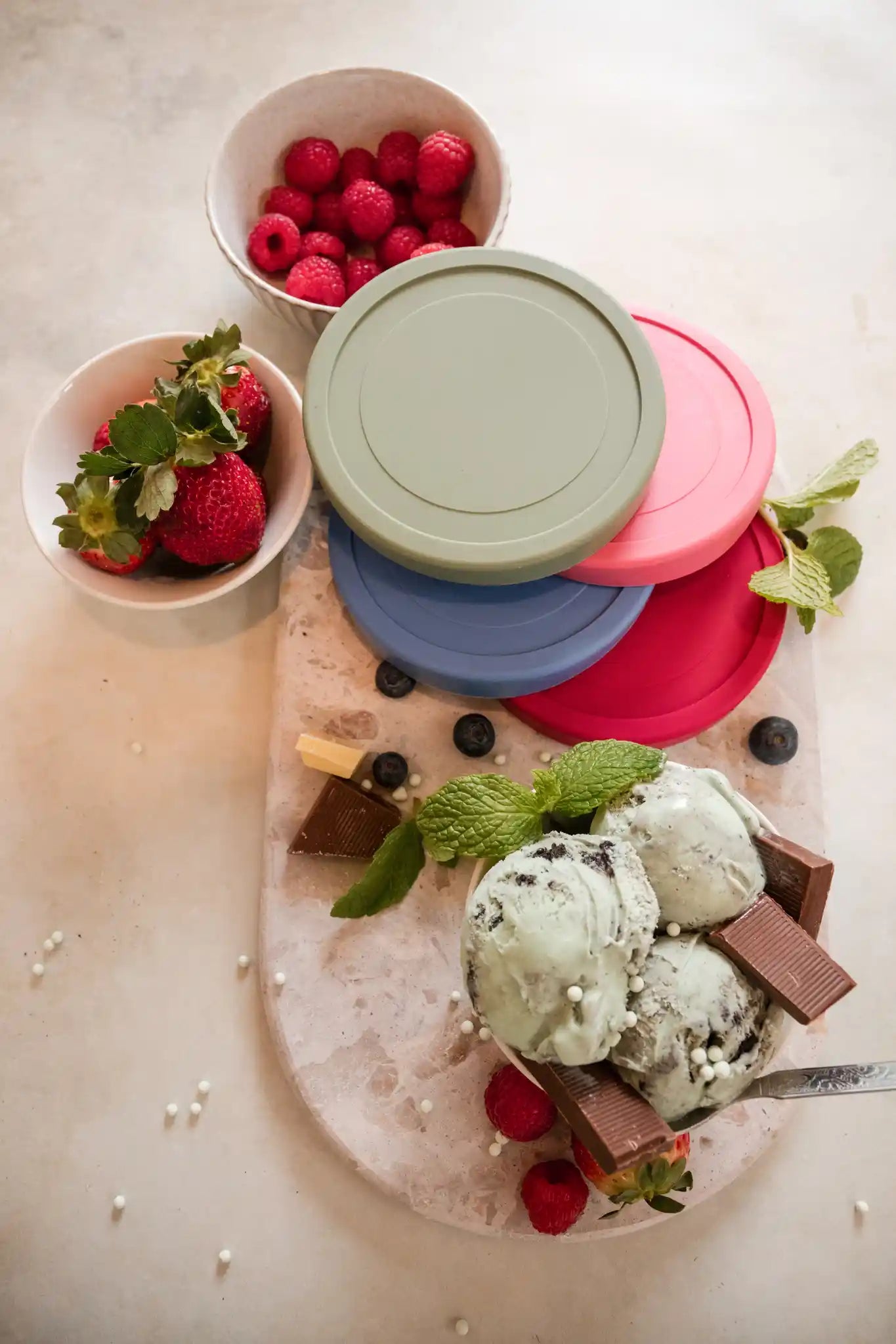 Starpack ice cream freezer storage containers with colorful, leak-proof silicone lids, designed for easy stacking and frost-free storage.
