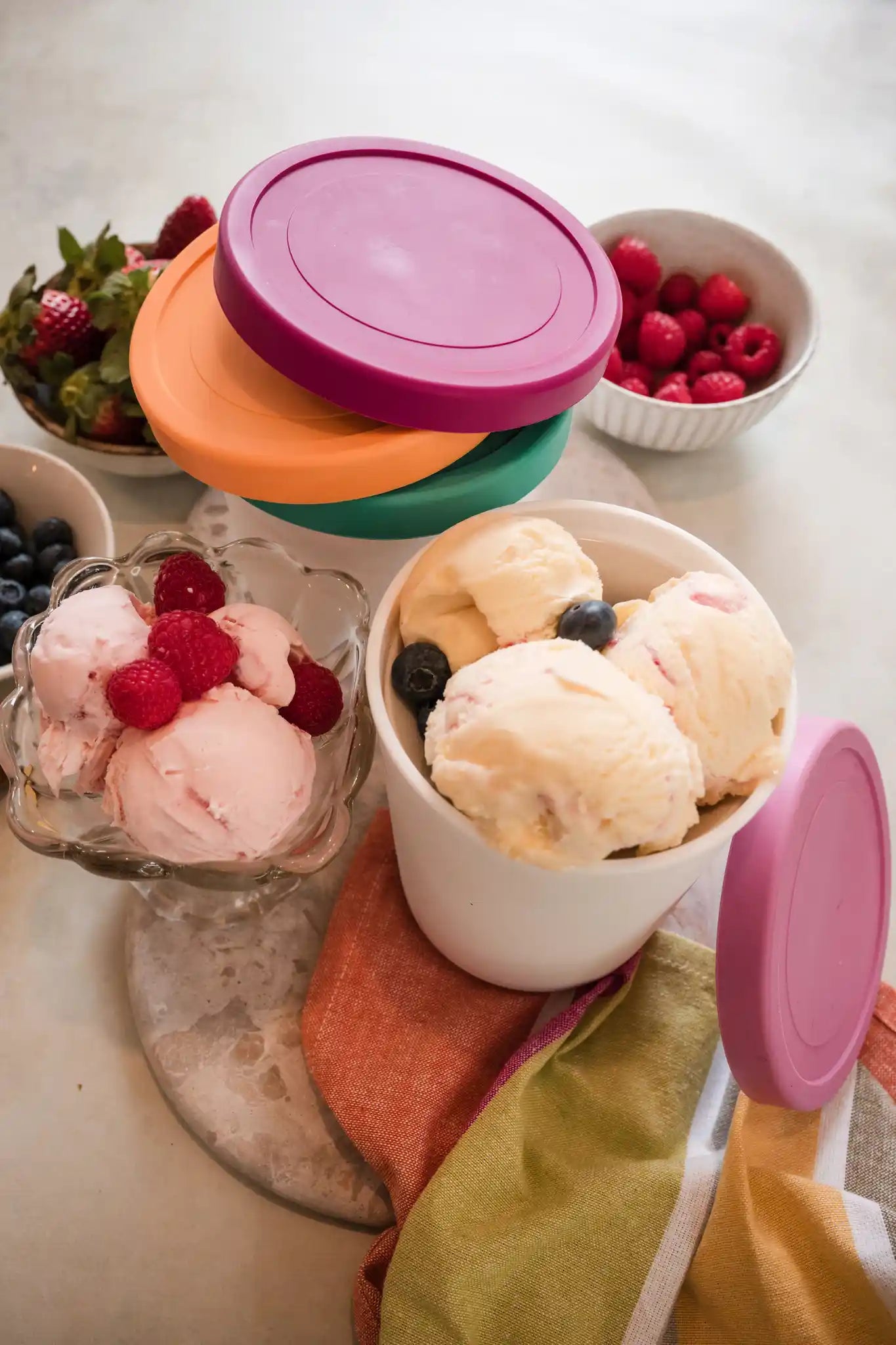 Starpack ice cream freezer storage containers with colorful, leak-proof silicone lids, designed for easy stacking and frost-free storage.