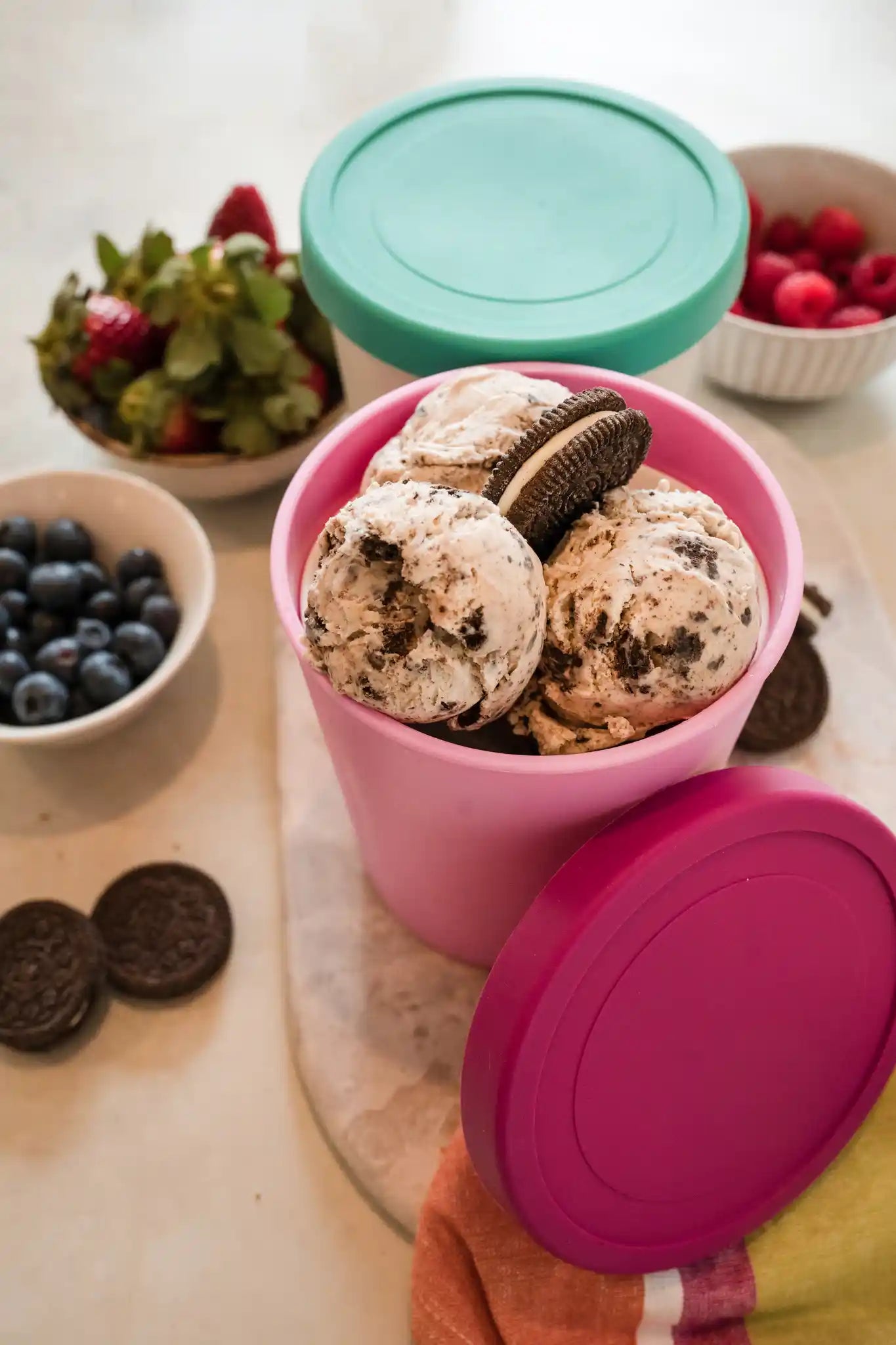 Starpack ice cream freezer storage containers with colorful, leak-proof silicone lids, designed for easy stacking and frost-free storage.
